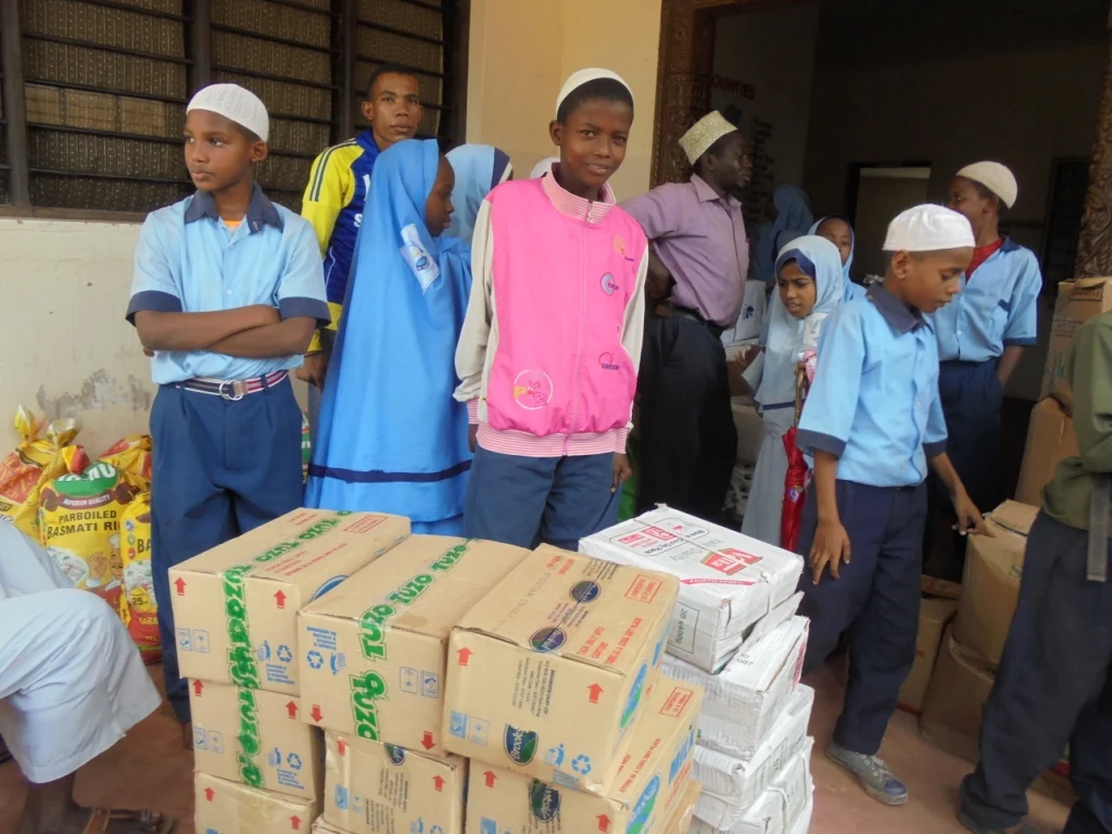 Basma walks with a Kidundo Foundation staff member 